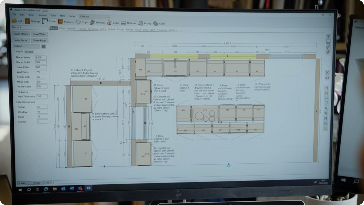 A computer screen displaying a detailed kitchen design layout with cabinets