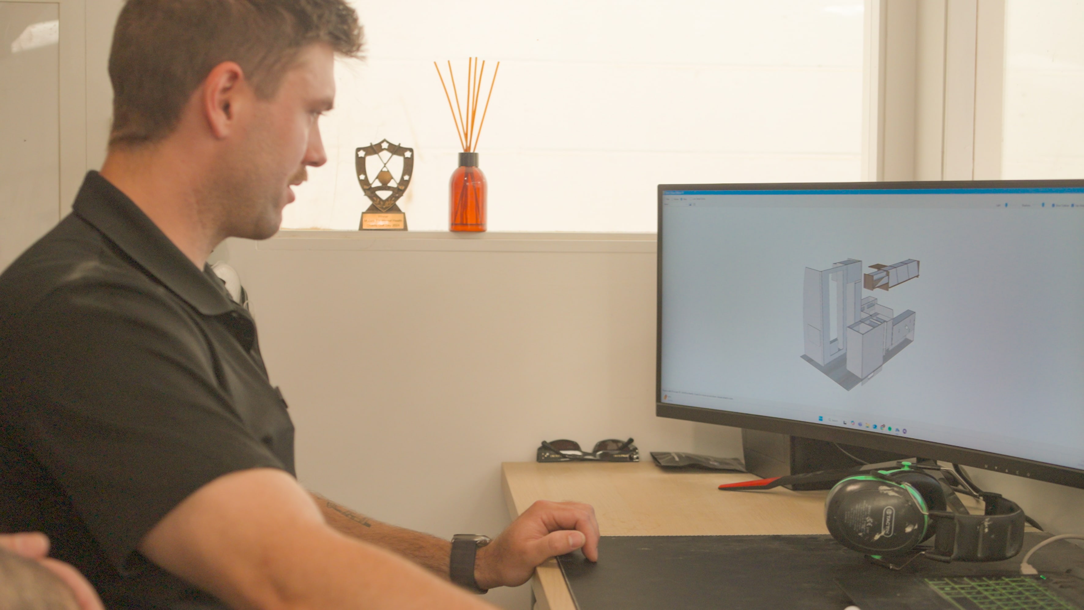 A man working at a desk with a computer